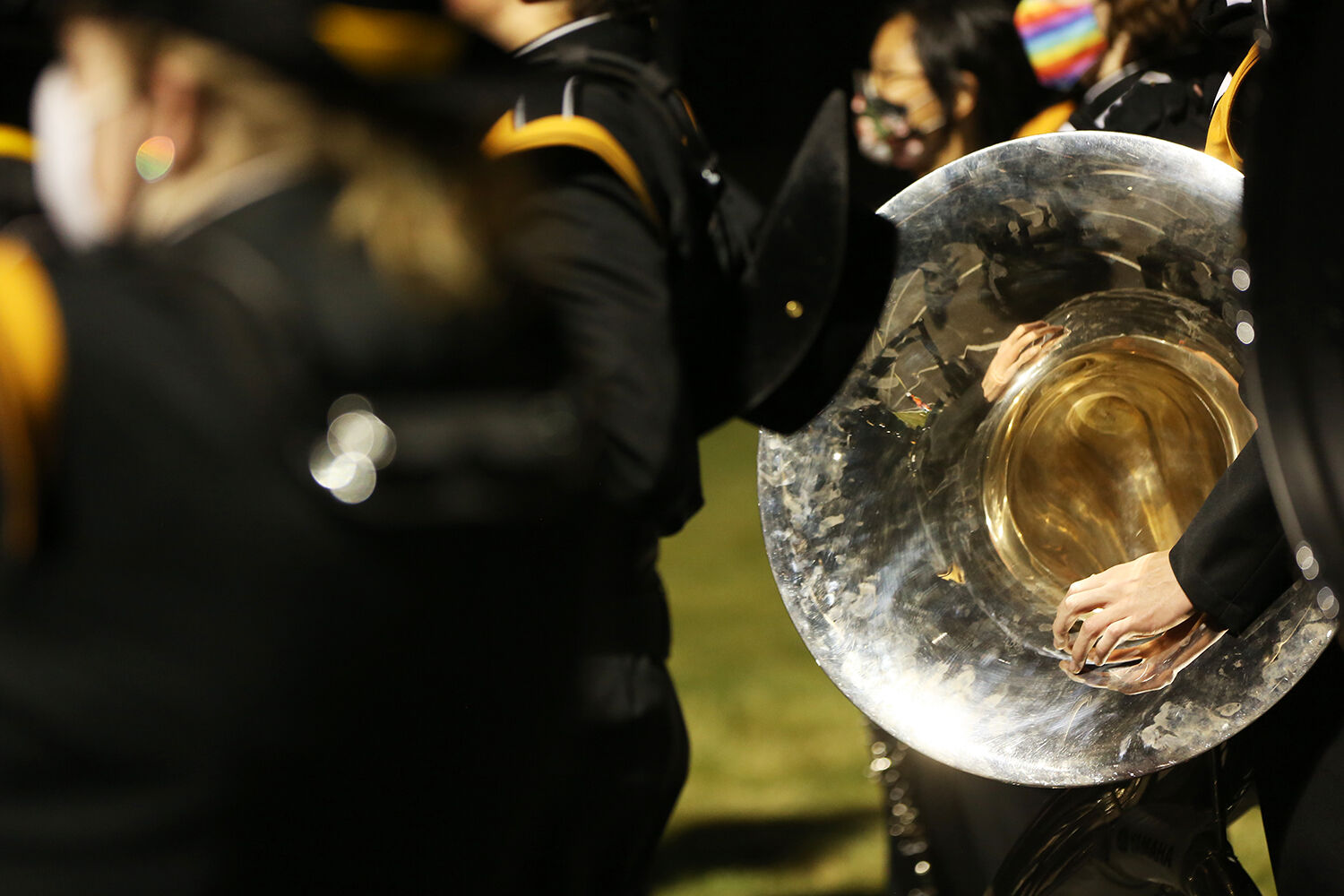 The band joins together on the far edge of the field